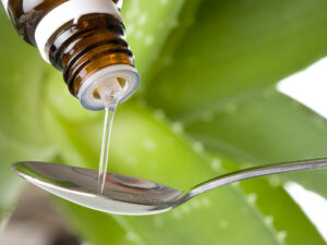 Herbal Medicine being poured into a spoon.